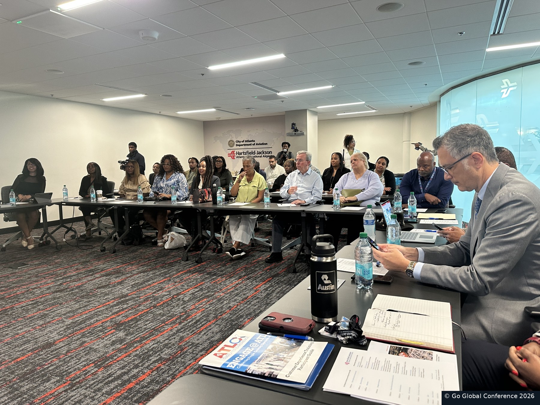 The delegation attending an airport briefing · GGC 2026
