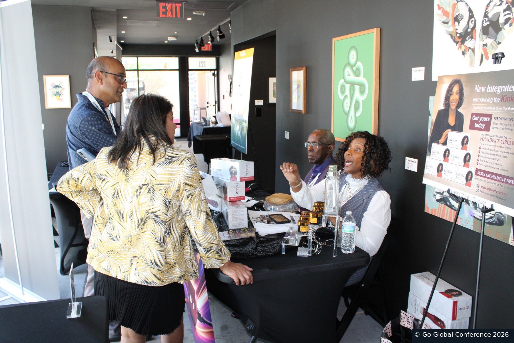 Delegates meeting at an exhibitor table · GGC 2026